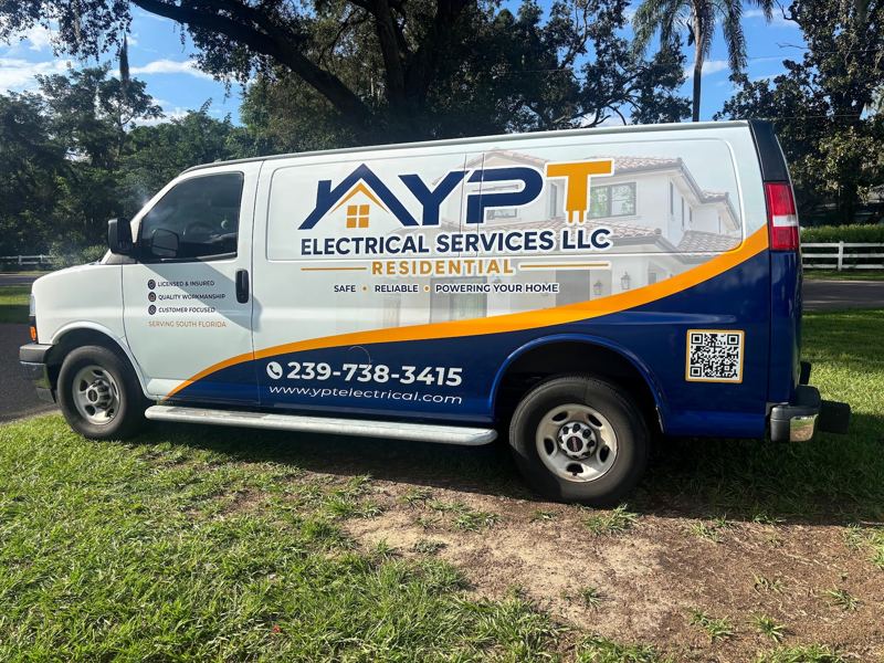 White and blue Chevrolet Express van with electrical services graphics