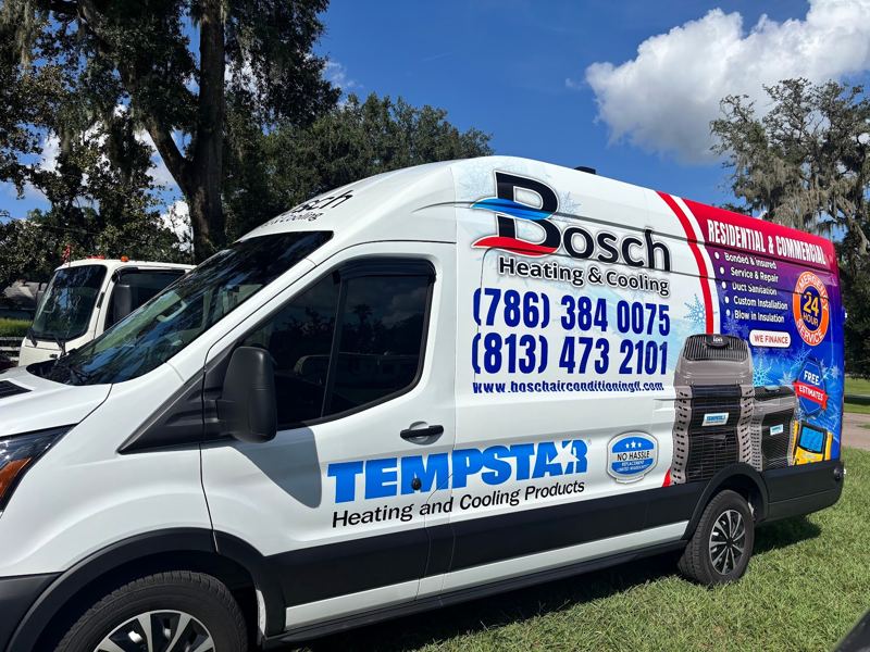 White Ford Transit van with heating and cooling company graphics